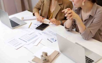 ''top view of peopl working together at the table with document and discuss money management