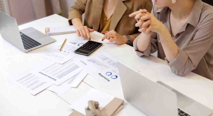 ''top view of peopl working together at the table with document and discuss money management
