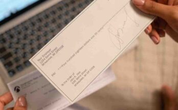Person reviewing bill and financial document while planning a budget to stop living paycheck to paycheck