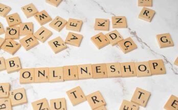 Wooden letter tiles scattered across a light marble surface, with the word'' online Shop'' spelled out in a center